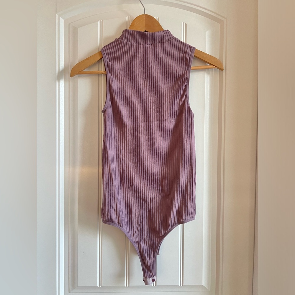 Ribbed sleeveless body suit. Purple. Size one size fits most.